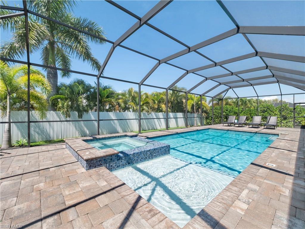 Image 3: Relaxing pool / spa featuring a sunroom, a lanai, and a patio