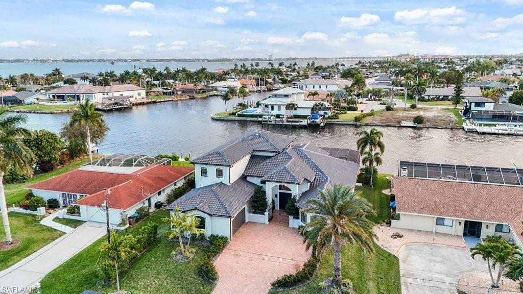 Image 1: Aerial view of residential area with a large body of water
