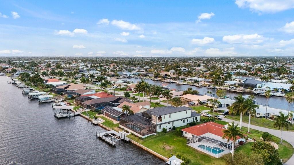 Image 4: Aerial view of residential area with a nearby body of water
