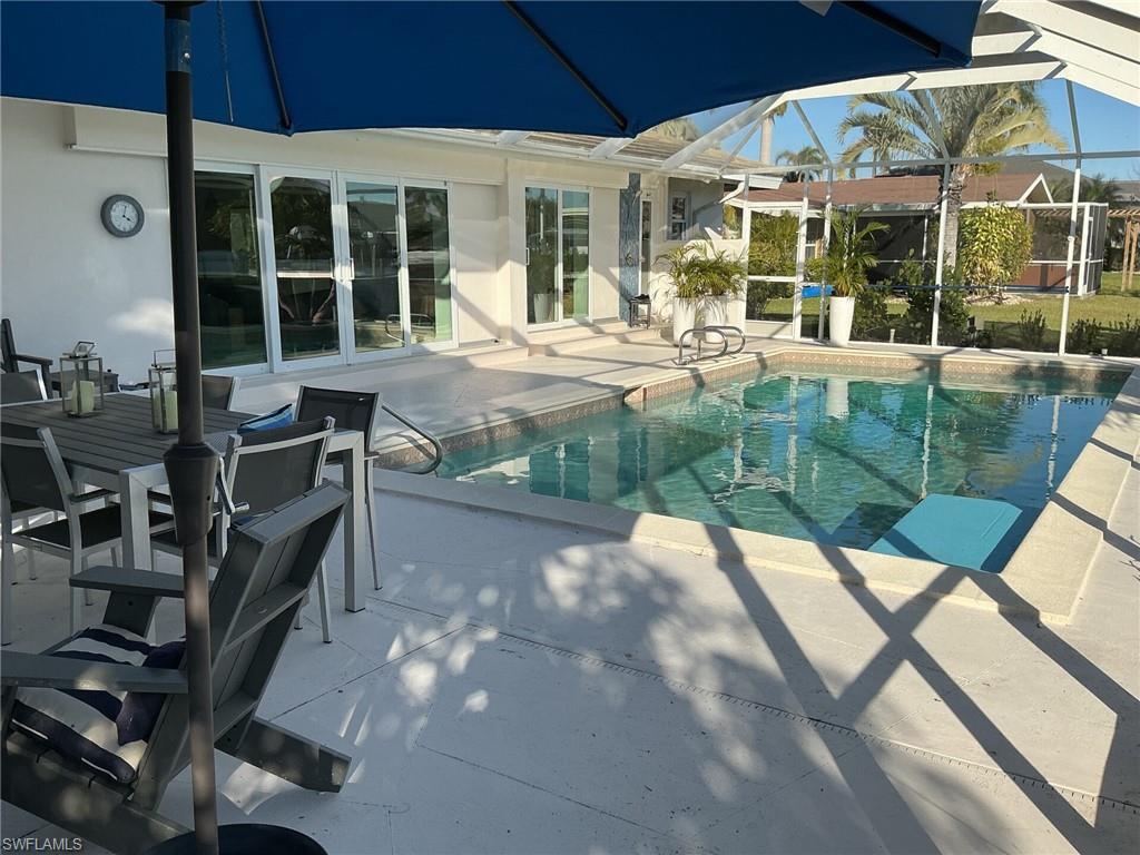 Image 4: Swimming pool featuring a patio area, a sunroom, and a lanai