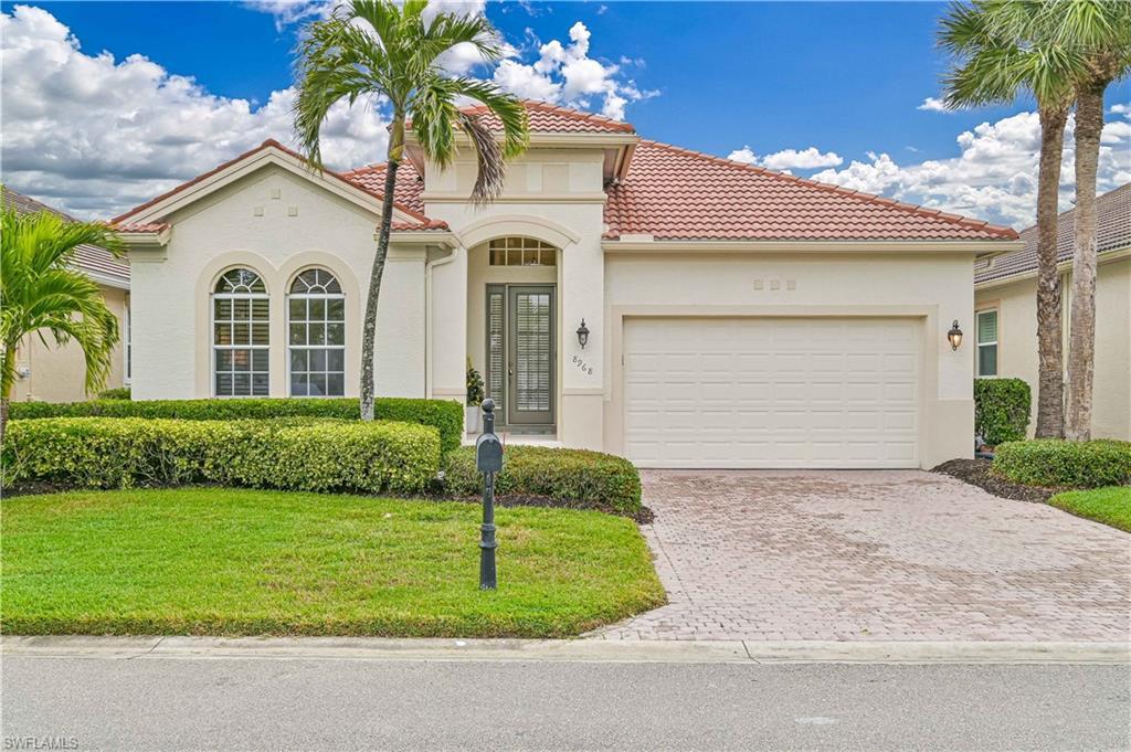 Image 1: Mediterranean / spanish-style home featuring an attached garage, stucco siding, decorative driveway, and a tiled roof