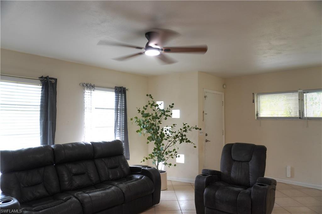 Image 4: Living area featuring ceiling fan and light tile patterned floors