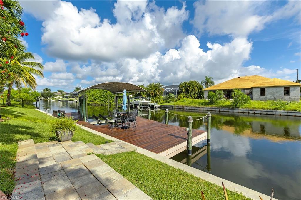 Image 3: Dock area with lift and a water view and a yard