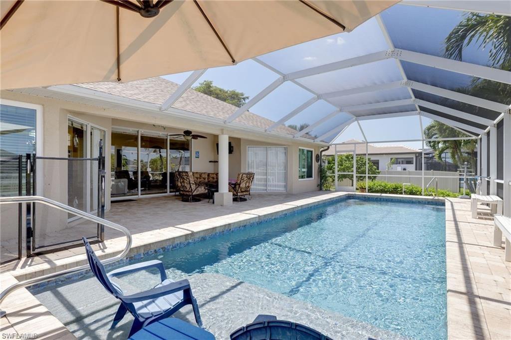 Image 4: Outdoor pool with a sunroom, a patio, glass enclosure, and a ceiling fan