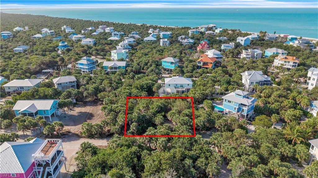 Image 3: Aerial view of 4521 Oro Pesos Lane (outlined in red) &mdash; nestled among established island homes on North Captiva, with the Gulf of Mexico visible just steps away.