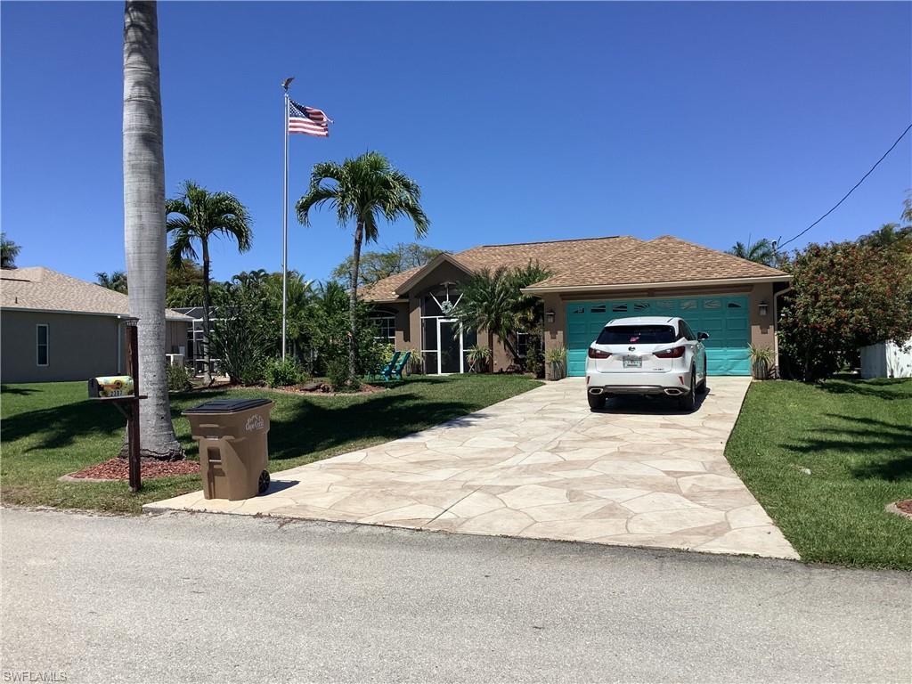 Image 1: Front of home with beautiful Royal Palms