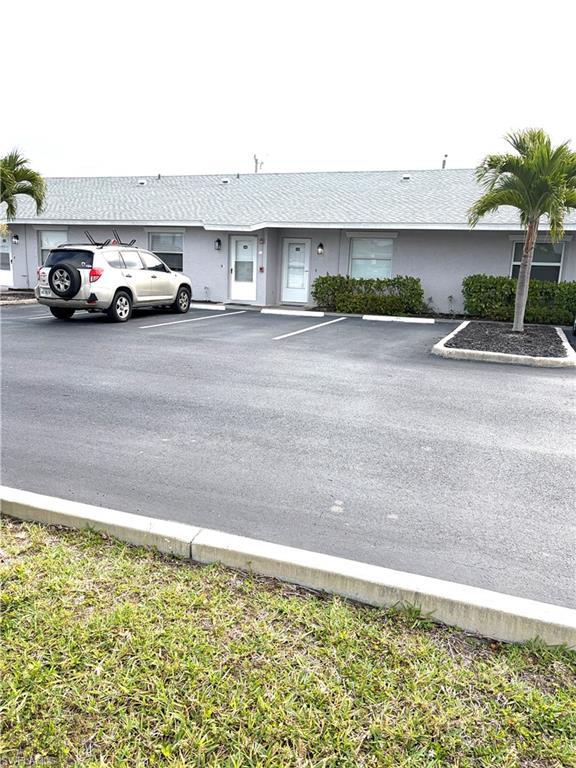 Image 2: Unit 115 parking space and front door Entrance