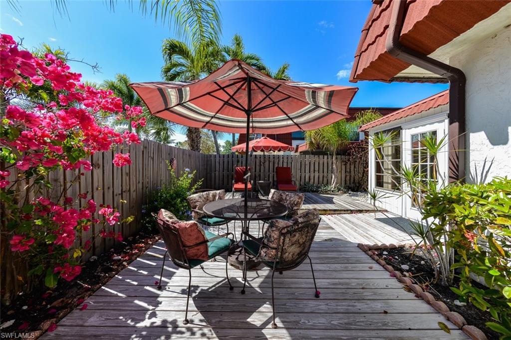Image 2: Townhome features a Large Private Courtyard with Patio Tables, Umbrellas and lounge chairs. Your Private Slice of Paradise in the Sun! Lovely Heated Pool is just steps from your gate !