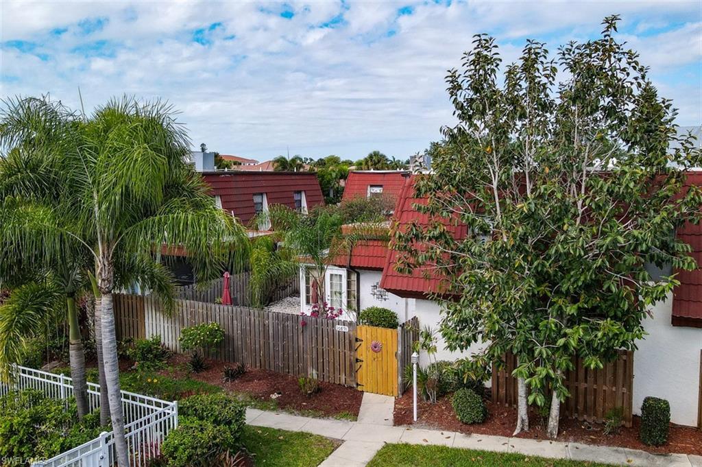 Image 3: Aerial View of Front of Townhome shows Pool Area to left of the townhome entrance gate. Includes 2 assigned parking spaces in front of the gate.