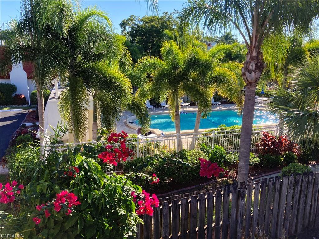 Image 4: Private Balcony off the primary bedroom. Overlooks the private courtyard and views of the Pool that is just steps away from your townhome.
