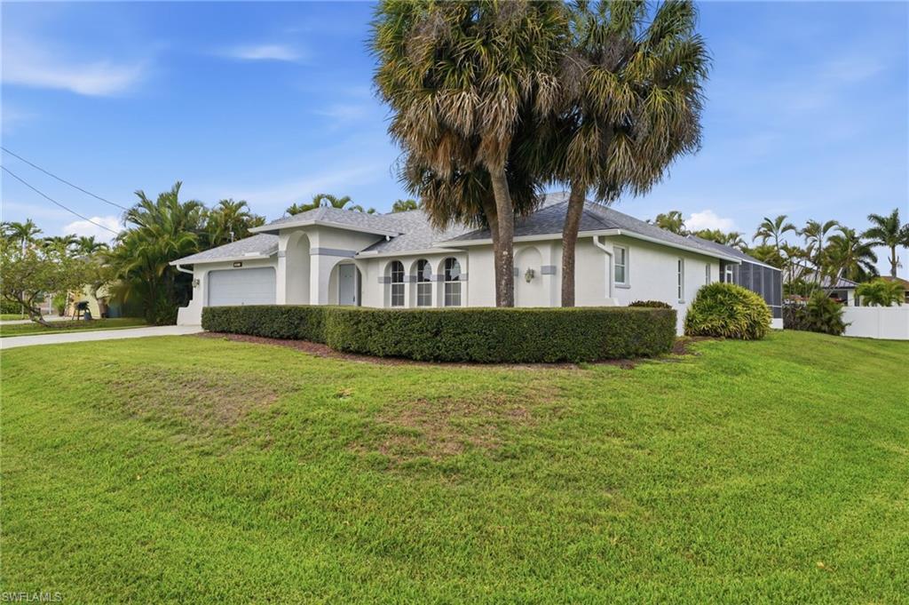 Image 3: White stucco exterior with a gray tile roof