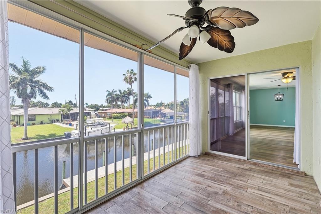 Image 2: Lanai measures appx 14'x7' and offers a great view of the canal. Easily accessed by living room sliders. Acrylic sliders with screens on canal side open/close to allow all season use.