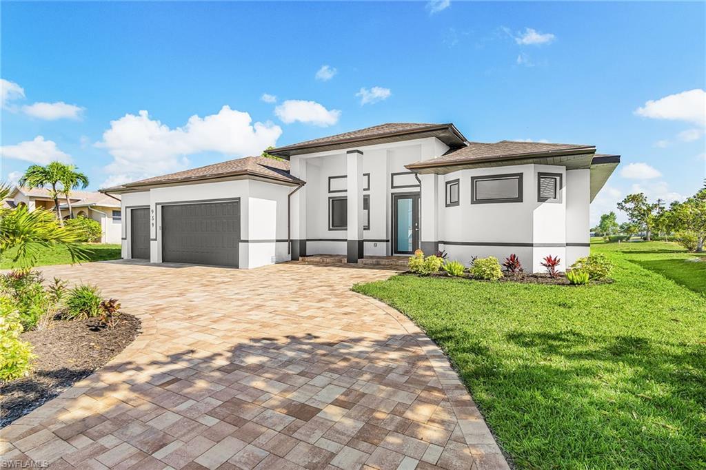 Image 3: Contemporary exterior with a multi-tone paver driveway