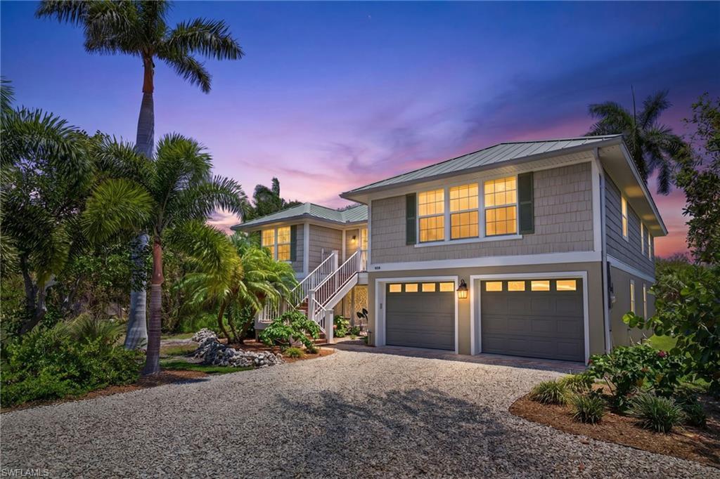 Image 3: Two-story coastal-style residence featuring a metal roof and shingle siding
