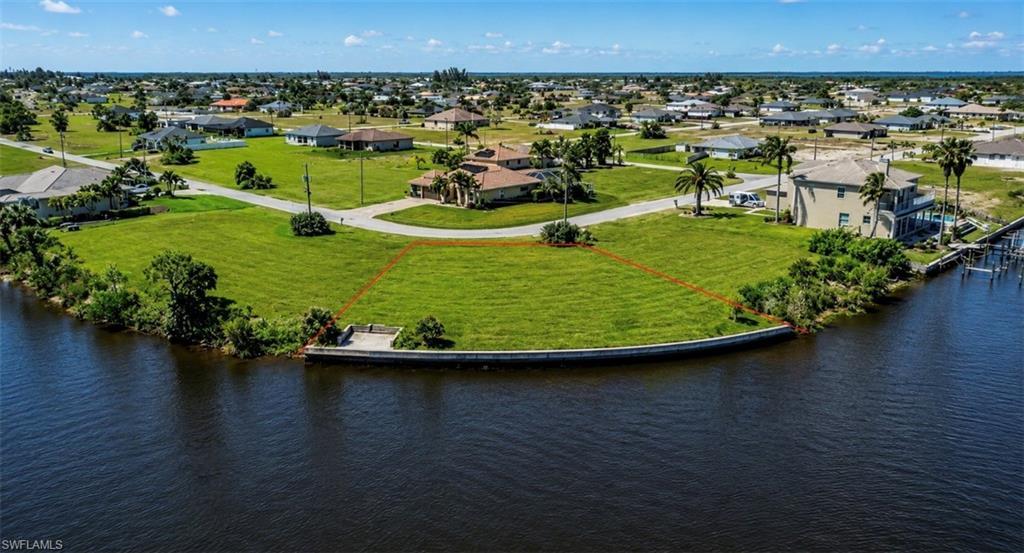 Image 1: Waterfront lot featuring a seawall and direct water access