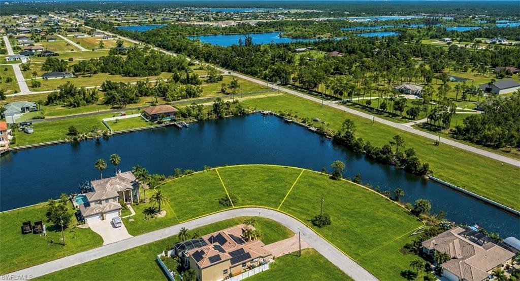 Image 2: Expansive waterfront lots featuring direct canal access, lush green landscaping, and established residential surroundings