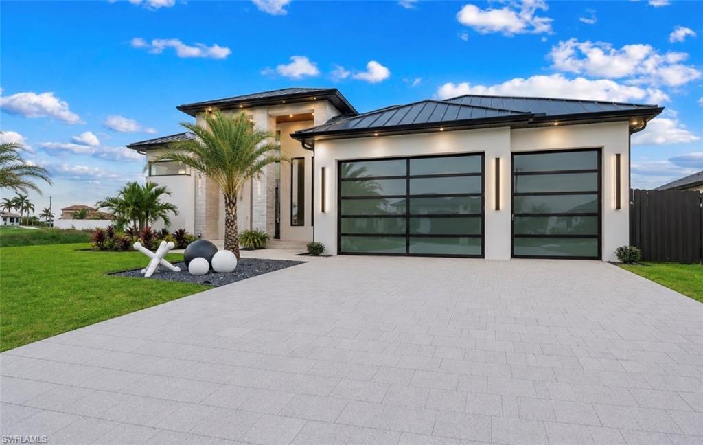Image 4: Contemporary exterior with a smooth stucco finish and a dark metal roof