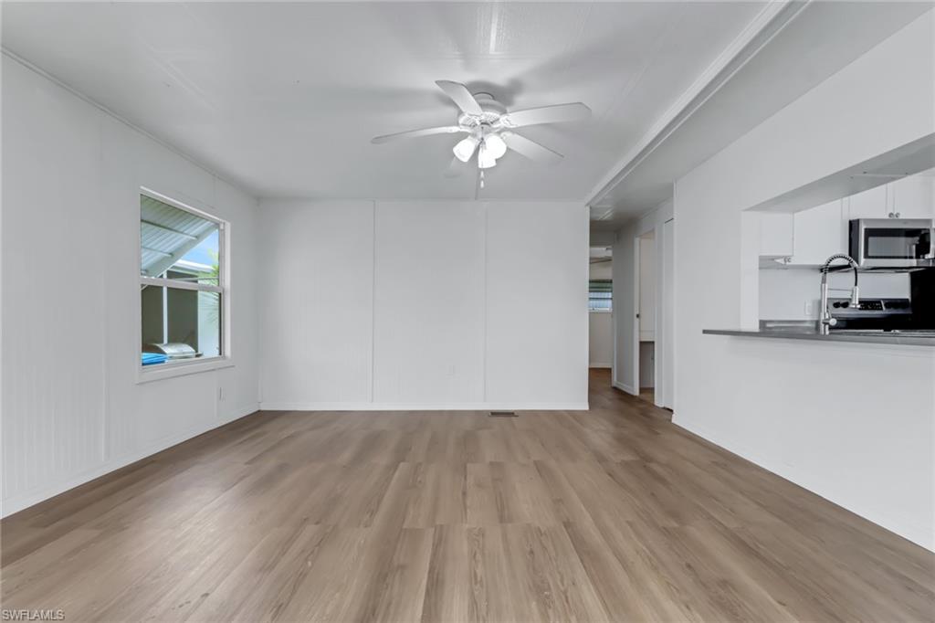 Image 2: Living Area with Luxury Vinyl Plank Flooring