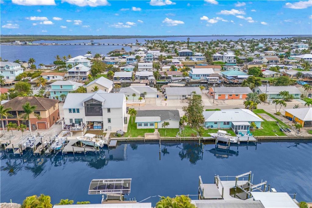 Image 2: Aerial shot capturing the home&rsquo;s prime waterfront location and direct canal access.
