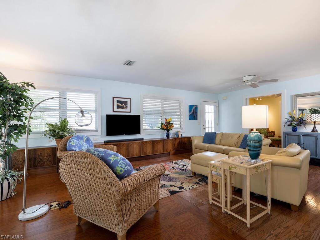 Image 3: Living room featuring wood flooring, natural light & ceiling fan