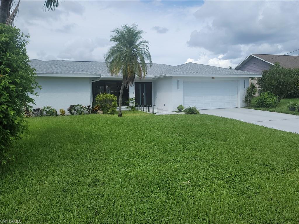 Image 3: Ranch-style house featuring stucco siding, concrete driveway, a front lawn, and an attached garage