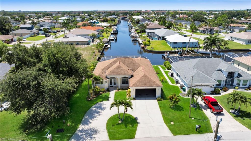 Image 1: Aerial perspective of suburban area with a large body of water