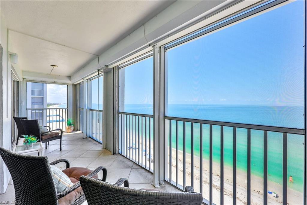 Image 2: Sunroom / solarium with a view of the beach and a water view