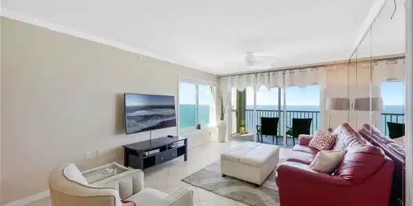 Image 3: Tiled living room with a water view, ceiling fan, and crown molding