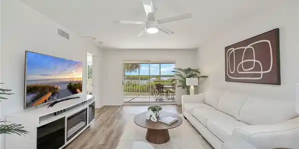 Image 3: Living room with ceiling fan and light wood-style floors