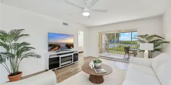 Image 4: Living room with wood finished floors and a ceiling fan