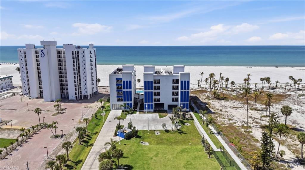 Image 4: Aerial view of unending shoreline and apartment complex / building