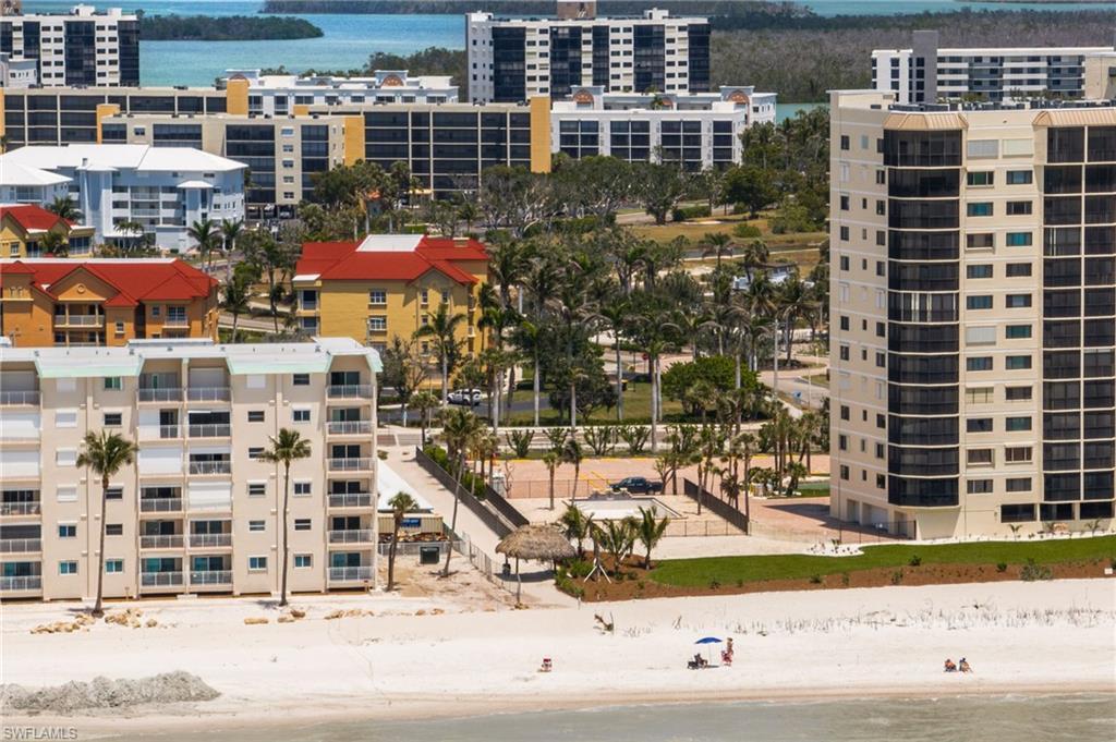 Image 2: Aerial view of extended coastline and apartment complex / building