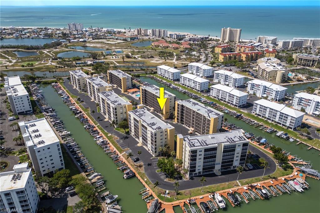 Image 4: View of property location featuring a large body of water and nearby urban area