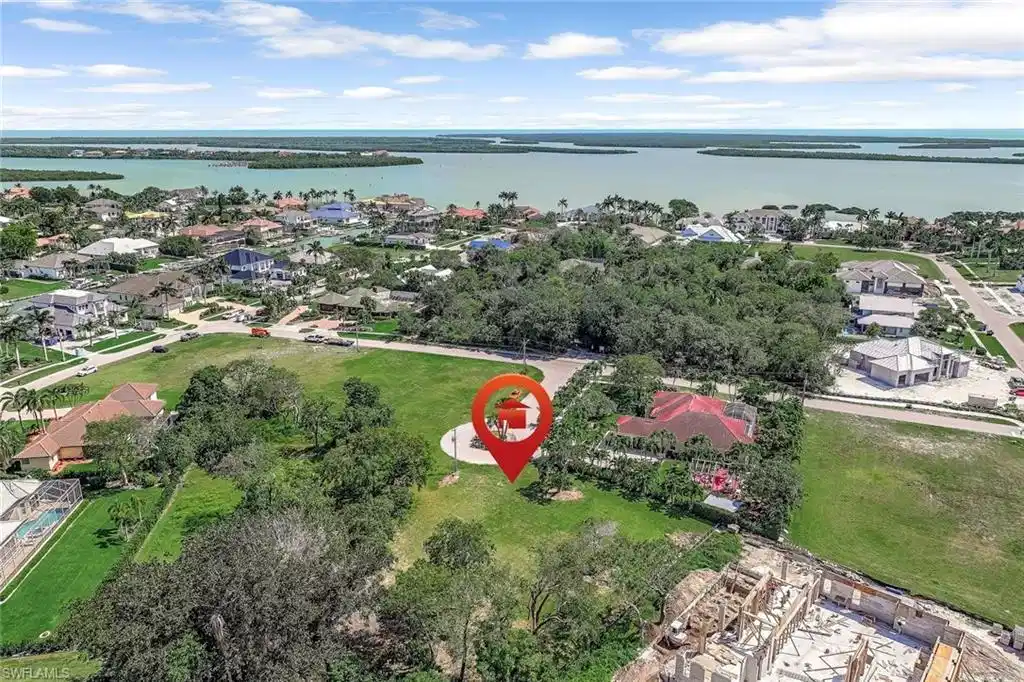 Image 1: Aerial perspective of suburban area with a nearby body of water