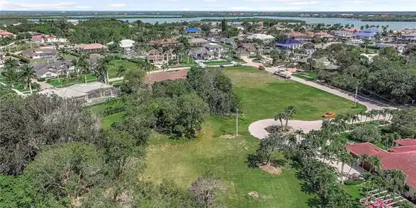 Image 2: View of property location featuring a large body of water and nearby suburban area