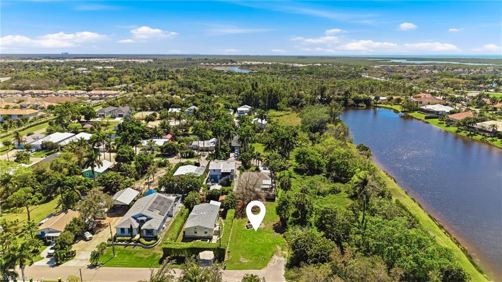 Image 2: Aerial perspective of suburban area with a large body of water