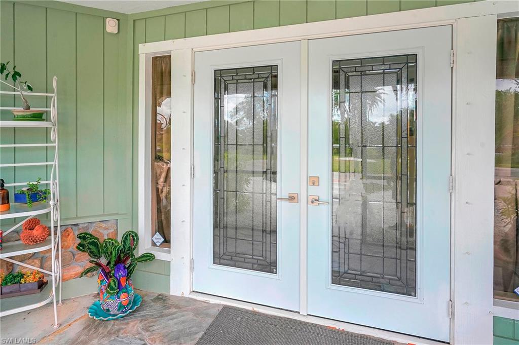 Image 2: Property entrance with french doors