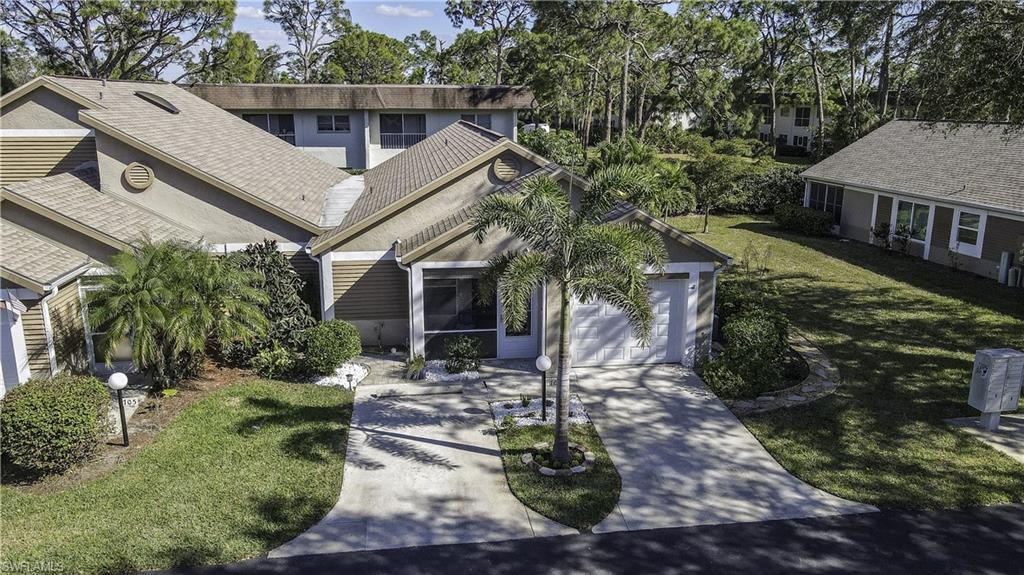Image 3: Property exterior featuring a single-car garage, concrete driveway, and mature landscaping