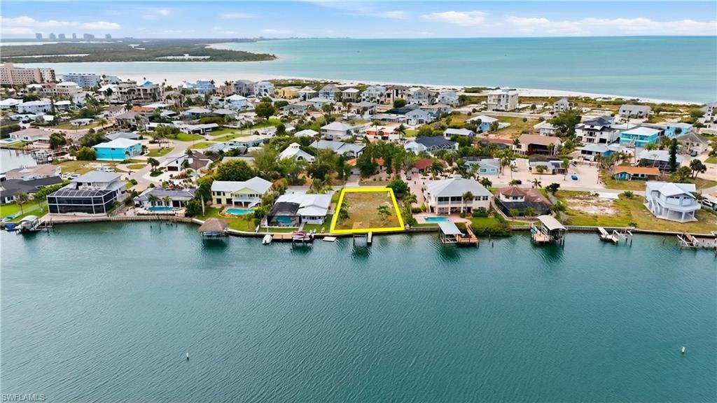 Image 1: Aerial perspective of suburban area with a large body of water - Virtually Edited Image