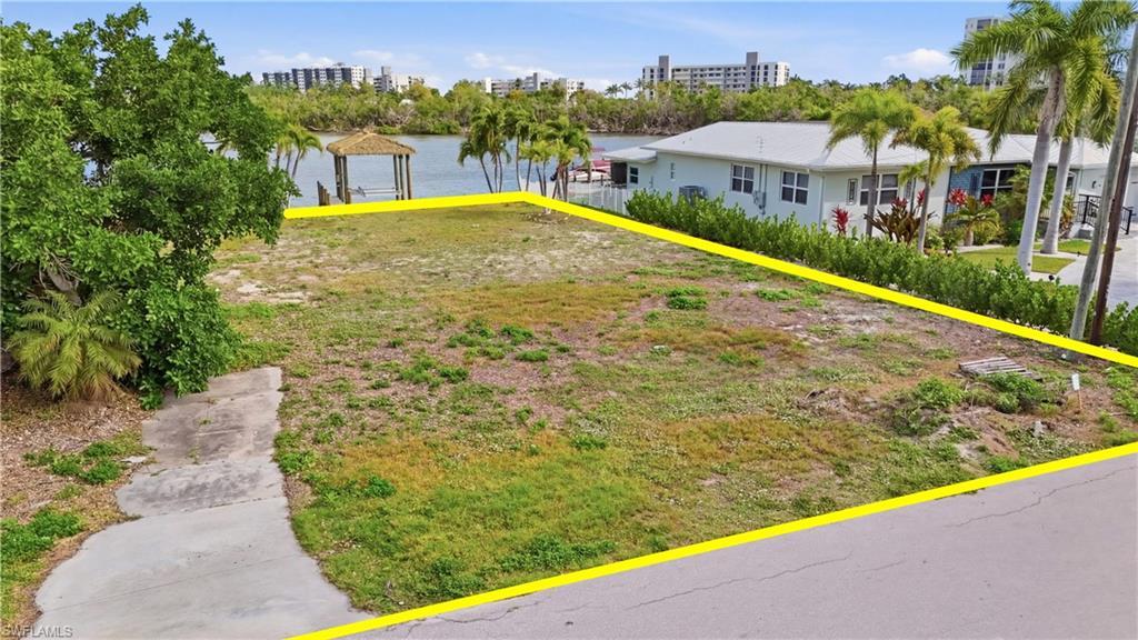 Image 4: View of yard featuring a water view - Virtually Edited Image