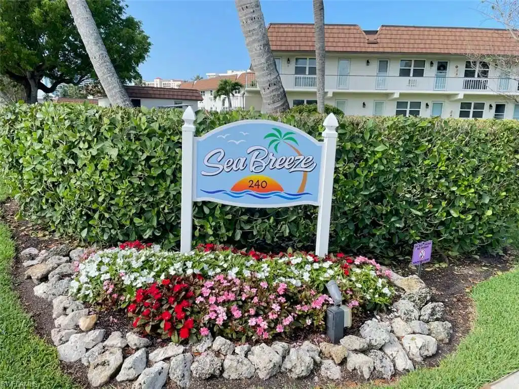 Image 1: "Sea Breeze" signage with decorative landscaping, featuring a variety of colorful annuals and natural rock accents
