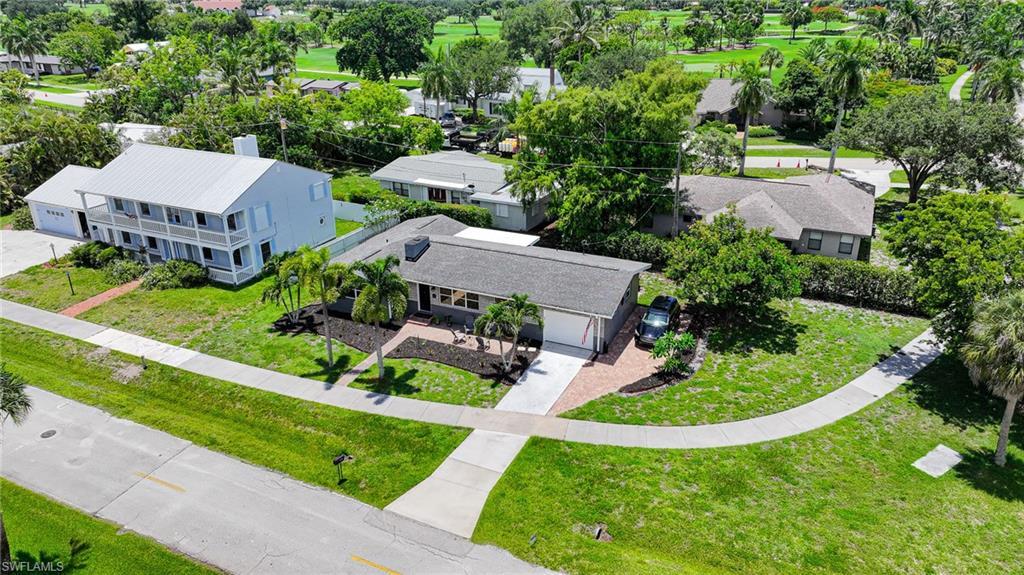 Image 4: Single-story residence featuring a gray shingle roof, attached garage, and a brick paver driveway