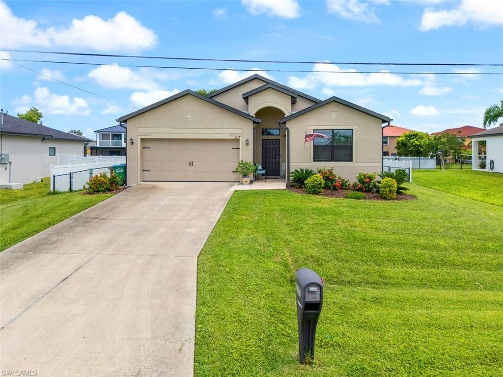 Image 3: Single story home with stucco siding, concrete driveway, and a garage