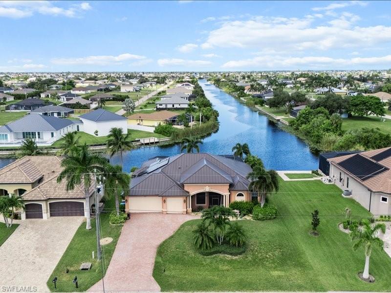 Image 3: Aerial view of residential area with a large body of water