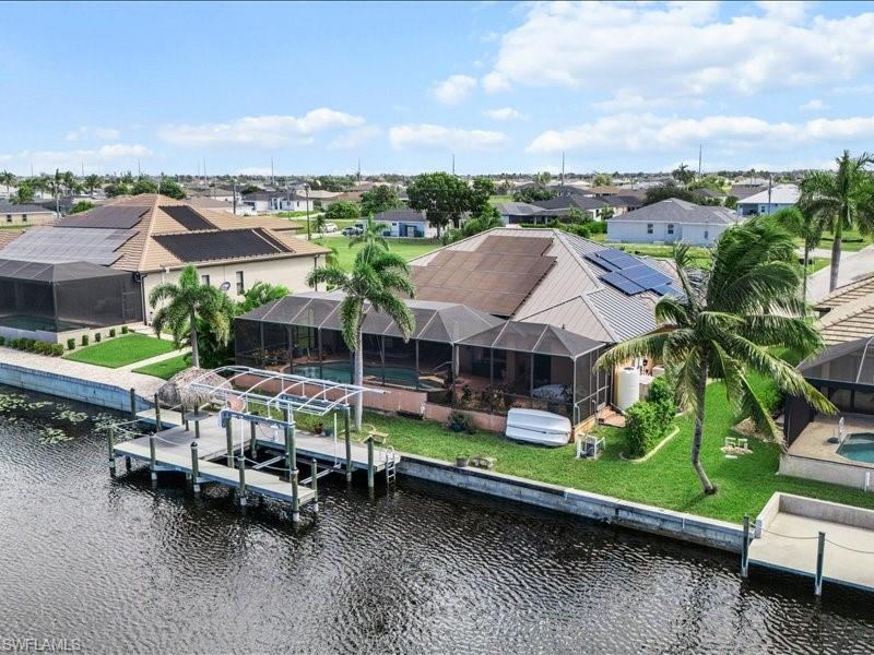 Image 4: Aerial perspective of suburban area featuring a large body of water