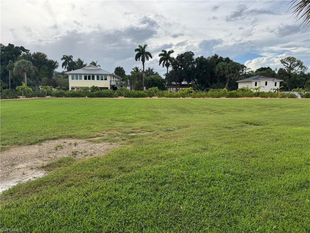 Image 3: View of grassy yard with view of scattered trees