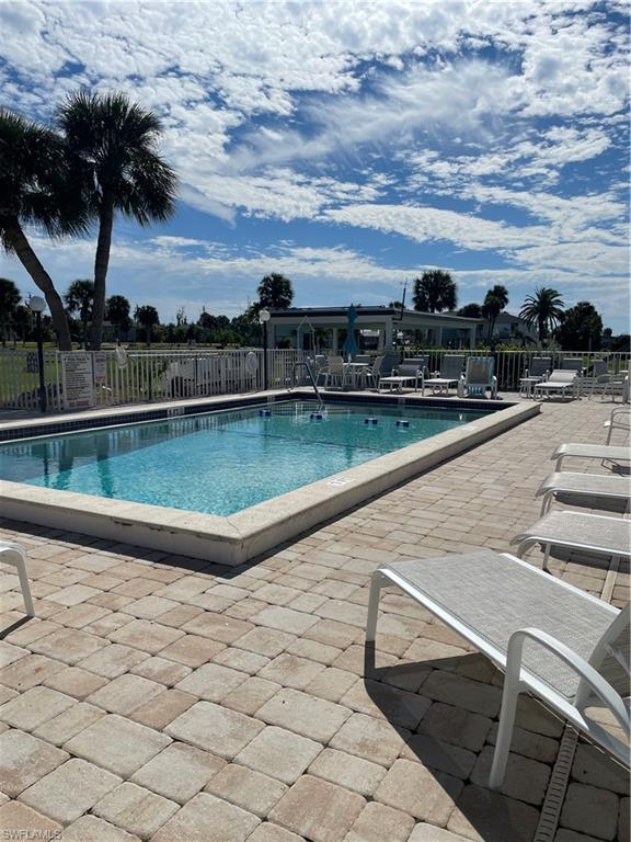 Image 4: Community pool with a patio area