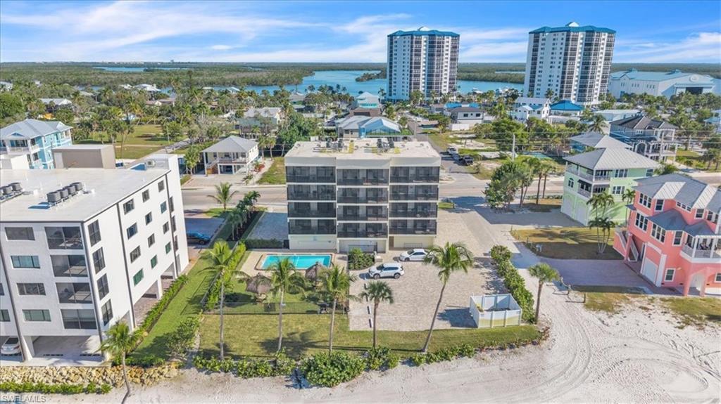 Image 1: Drone / aerial view of a large body of water and apartment complex / building