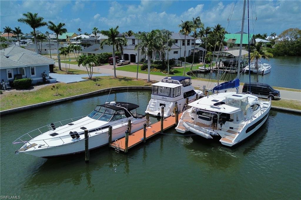 Image 4: Dock area with a water view and a residential view