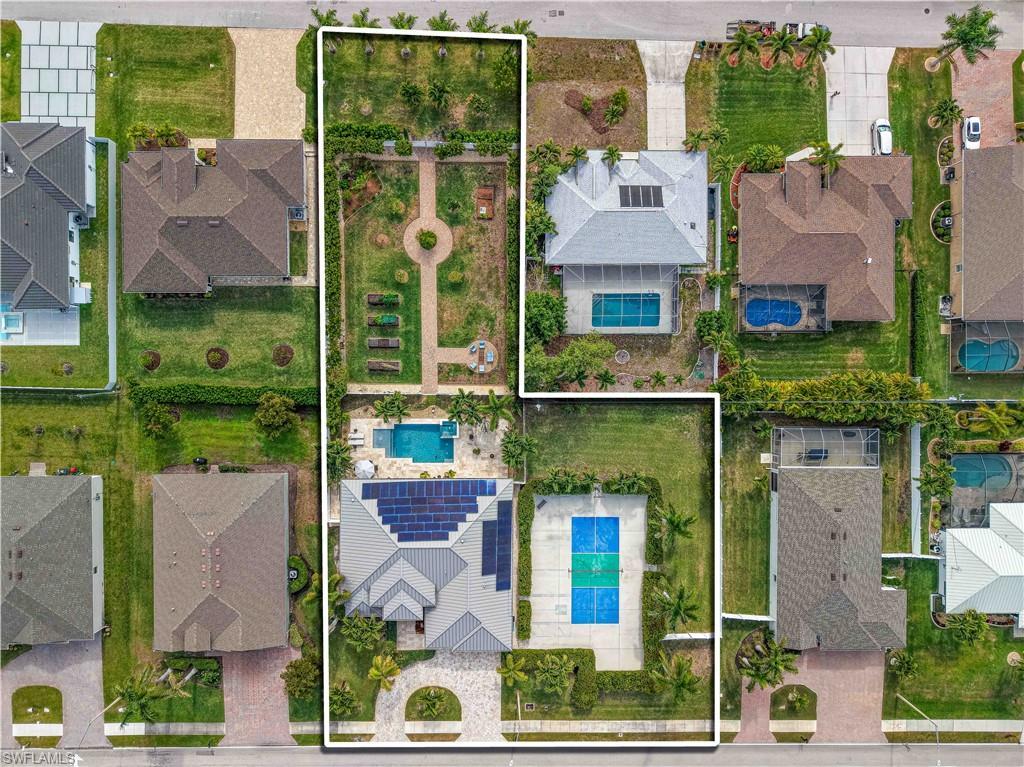 Image 3: Aerial view of residential area with property parcel outlined and a pool